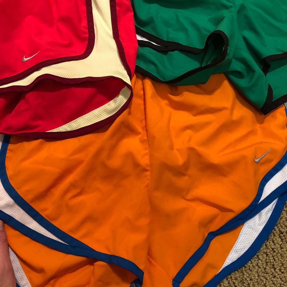 Orange Nike running shorts